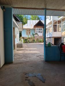 an empty room with a blue door in a house at Geust house Paradise in Arslanbob
