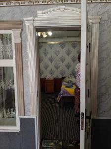 a door to a room with a bed in it at Geust house Paradise in Arslanbob