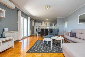 a living room with a couch and a table at Villa Elder ZadarVillas in Donji Lepuri +37 photos