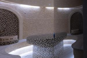 a lobby with a circular table in a building at The Landmark Villas & Spa in Kolymbia