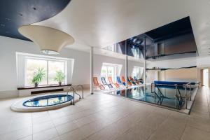 a living room with a pool and a table and chairs at Komorni Hurka in Cheb