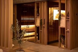 a room with glass doors and a plant in a vase at Rezydencja AMBRE in Łeba