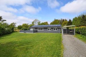 a black house with a soccer field in front of it at C11629-Hemmet-Ildervej-10 in Hemmet