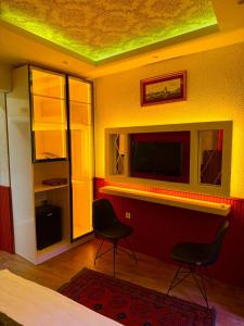 a living room with two chairs and a television at elisa hotel in Istanbul