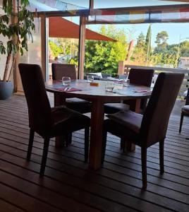 a wooden table and chairs on a deck at Peyrascas in Sanary-sur-Mer
