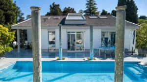 a house with a swimming pool in front of a house at Luxury suite Portorož in Portorož +68 photos