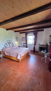 a bedroom with a bed and a brick floor at Villa Matilda ad Ansedonia in Orbetello +83 photos