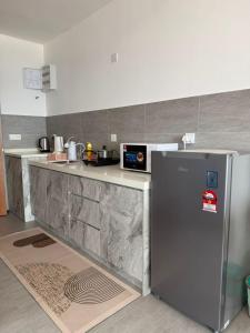 a kitchen with a stainless steel refrigerator and a counter at Cozy Stay Studio in Shah Alam +10 photos