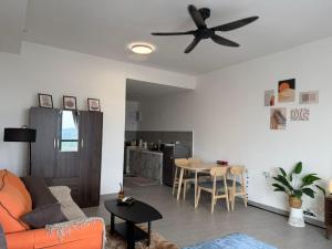 a living room with a couch and a ceiling fan at Cozy Stay Studio in Shah Alam