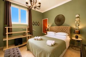 a bedroom with a bed with two towels on it at Panorama Suites Noto - Adults Only in Noto