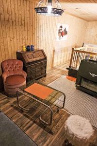 a living room with a chair and a table at Chalet Le Châtelaret by Interhome in Finhaut