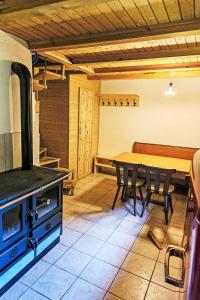 a kitchen with a stove and a table with chairs at Chalet Le Châtelaret by Interhome in Finhaut +10 photos