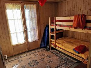 a room with two bunk beds and a window at Chalet Le Châtelaret by Interhome in Finhaut