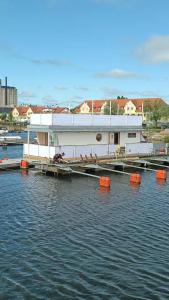 a boat is docked at a dock in the water at Unique floating retreat Sleeps 4 in Sölvesborg