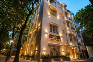 a large white building with a sign on it at Golden Palace in Kolkata