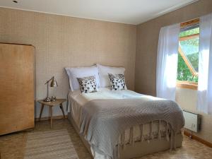 a bedroom with a bed with pillows and a window at Lyngtun in Ørskog