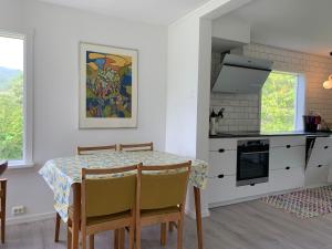 a kitchen and dining room with a table and chairs at Lyngtun in Ørskog +23 photos