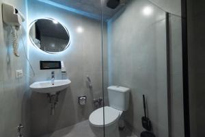 a bathroom with a toilet and a sink and a shower at Hotel Voyager in Tbilisi City +53 photos