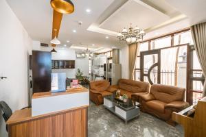 a living room with a couch and a table at May Bliss Villa in Danang
