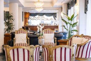 a dining room with chairs and a bar at Hotel Globus Pool & Beach in Milano Marittima