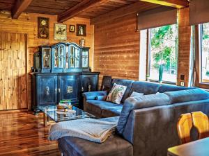 a living room with blue couches and a cabinet at Chalet Chata Ujo by Interhome in Hranice