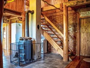 a wooden staircase in a room with a brick wall at Chalet Chata Ujo by Interhome in Hranice