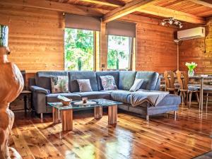 a living room with a blue couch and a table at Chalet Chata Ujo by Interhome in Hranice
