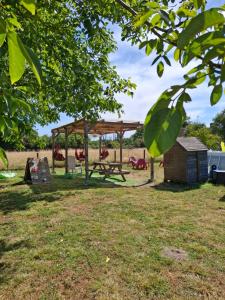 a picnic shelter and a picnic table in a park at Les châtillonnes 25 minutes du zoo de beauval in Châtillon-sur-Indre