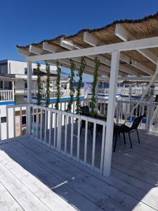 a pergola on the deck of a resort at Thea's Bungalow in Costinesti
