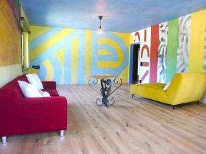 a living room with two couches and a table at Apartment Casa Malva by Interhome in Malvaglia