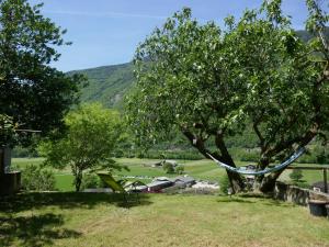a hammock under a tree in a yard at Apartment Casa Malva by Interhome in Malvaglia