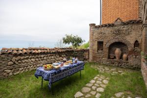 a table with food on it in front of a building at Lurji Bani in Sighnaghi