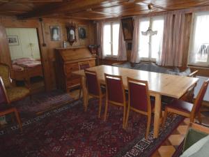 a dining room with a wooden table and chairs at Holiday Home by Interhome in Lungern