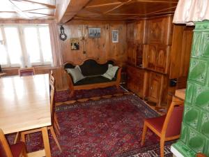 a living room with a couch and a table at Holiday Home by Interhome in Lungern