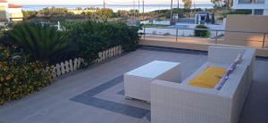 a patio with a chair and a table on a balcony at Villa Verona Pool in Lachania