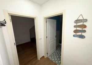 an empty room with a door and a sign on the wall at Casa na Aldeia in Melides