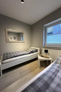 a bedroom with a bed and a window at Apartment FEWO „Am Stausee“ by Interhome in Friesoythe
