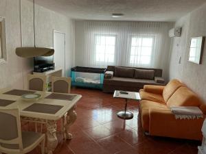 a living room with a couch and a table at Apartment Dorada in Dobra Voda