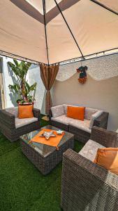 an outdoor patio with couches and an umbrella at VILLA MADRE in Marina Serra +17 photos