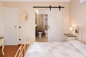 a bedroom with a bed and a bathroom with a toilet at B&B TORRE AZUL FRONTEMARE - Bisceglie in Bisceglie