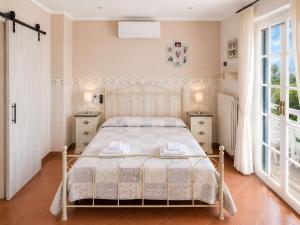a bedroom with a bed with two night stands and two windows at B&B TORRE AZUL FRONTEMARE - Bisceglie in Bisceglie