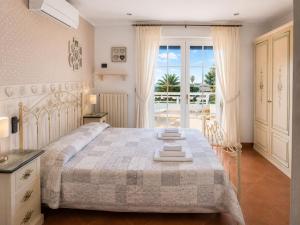 a bedroom with a large bed and a balcony at B&B TORRE AZUL FRONTEMARE - Bisceglie in Bisceglie