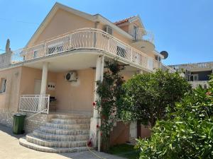 a building with stairs and a balcony on it at Apartment Dorada in Dobra Voda