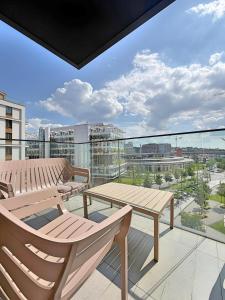 a balcony with benches and a view of a city at BW Premium One-Bedroom Apartments in Belgrade