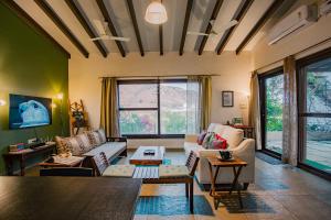 a living room with a couch and a table at Nivaant Villa by StayAtlas in Igatpuri