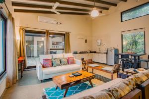 a living room with a couch and a table at Nivaant Villa by StayAtlas in Igatpuri