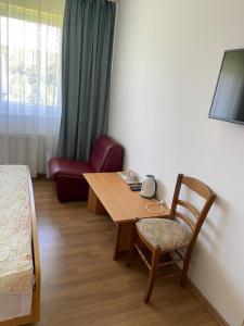 a room with a table and a chair and a bed at House Draga Plitvice near the lakes and bus stop in Plitvička Jezera