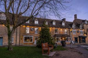 a christmas tree in front of a building at Cotswold Townhouse - Adults Only in Stow on the Wold