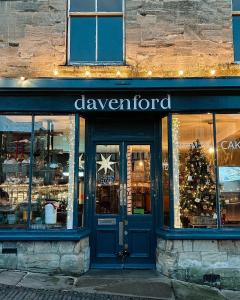 a store front with a christmas tree in the window at Cotswold Townhouse - Adults Only in Stow on the Wold