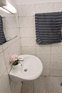 a bathroom with a white sink and a blue towel at Chez Bryan in Avéméné +5 photos